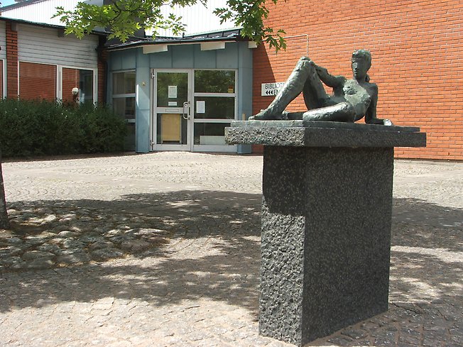 skulptur av en naken kvinna som ligger ner